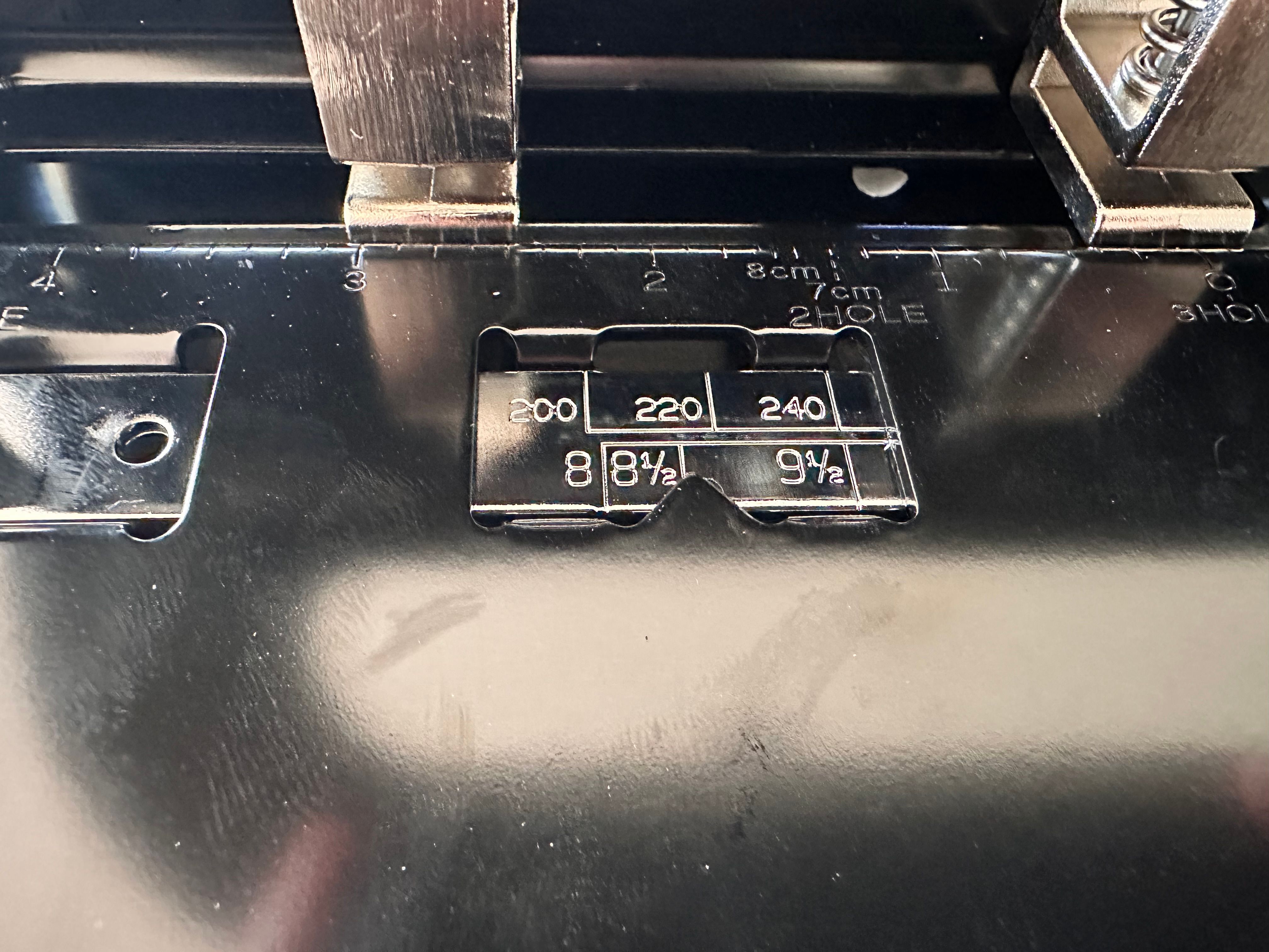 Sliding alignment guide with markings for common paper sizes