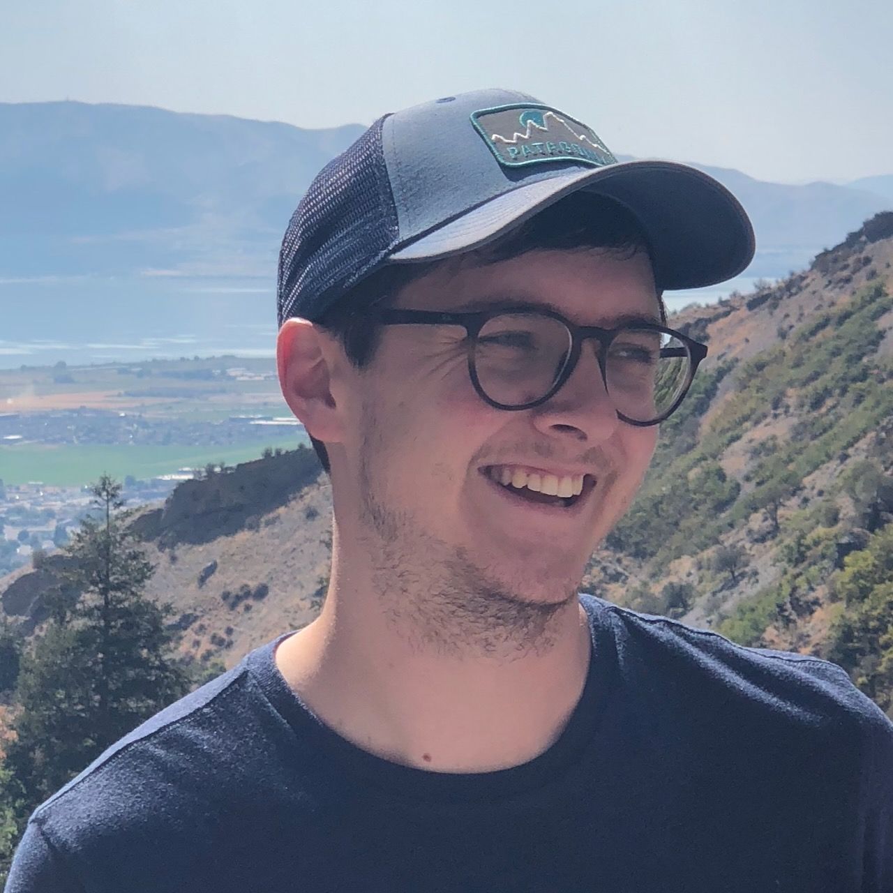 A headshot of Sam Warnick smiling